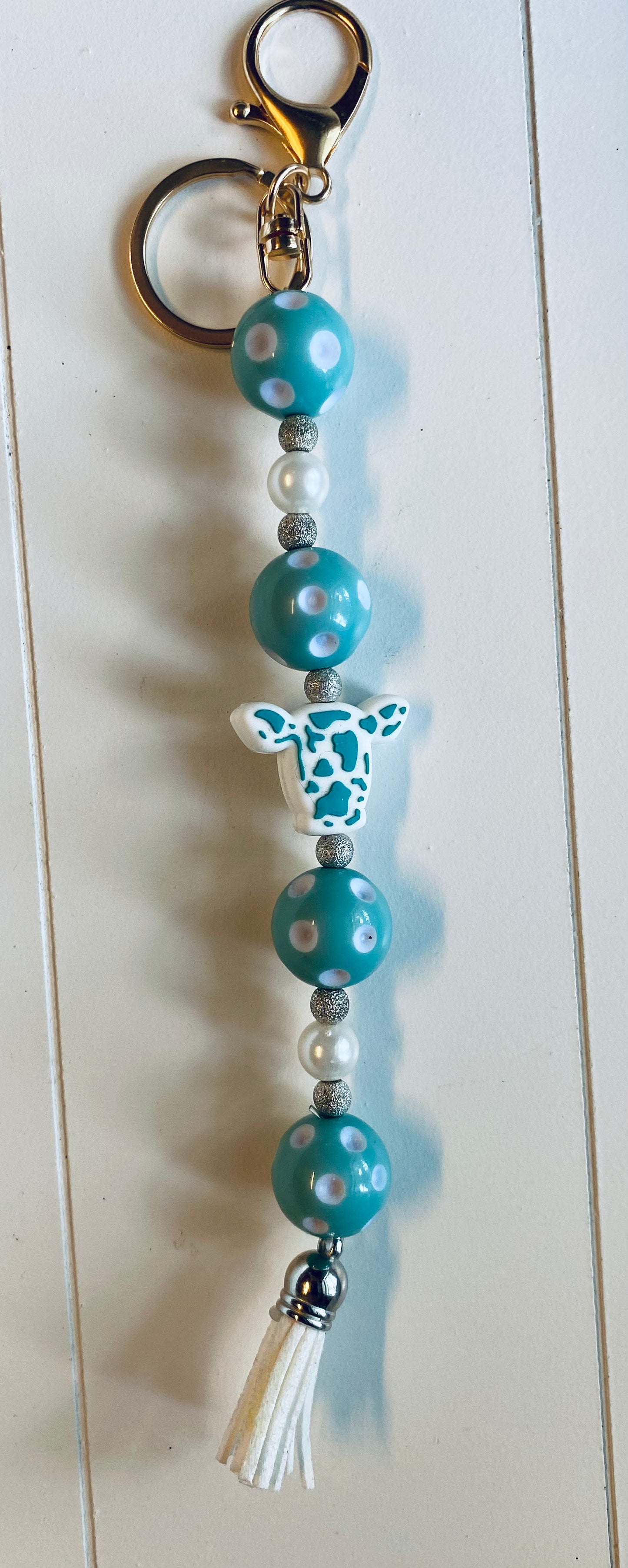 Teal and white cow head keychain