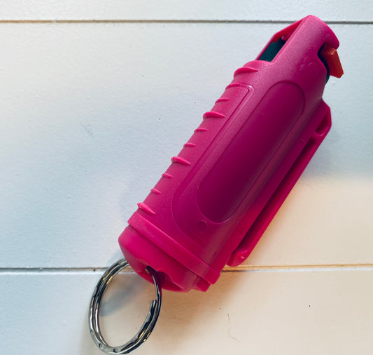 Dark pink pepper spray in plastic case